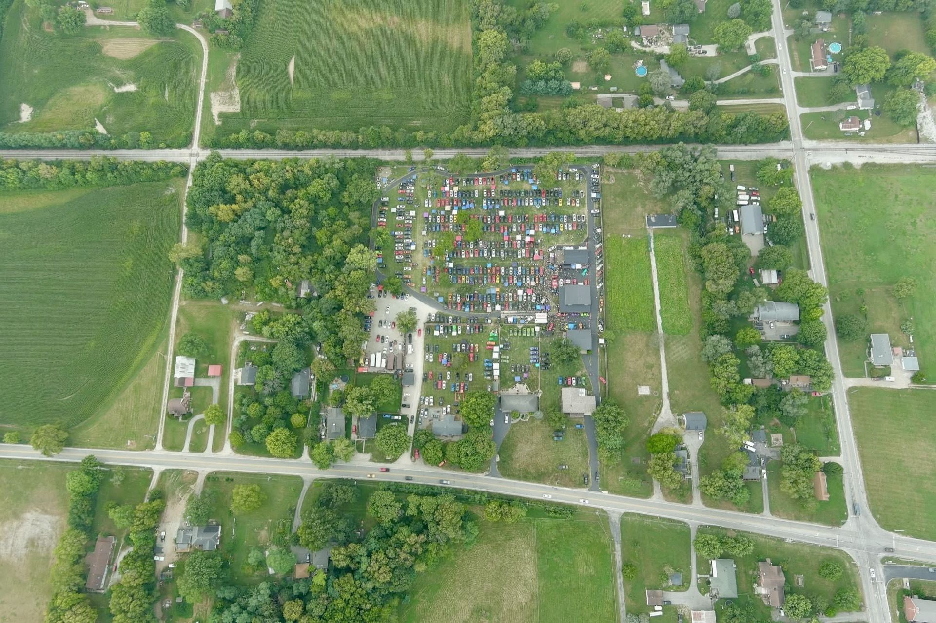 High aerial drone shot of the entire car show grounds